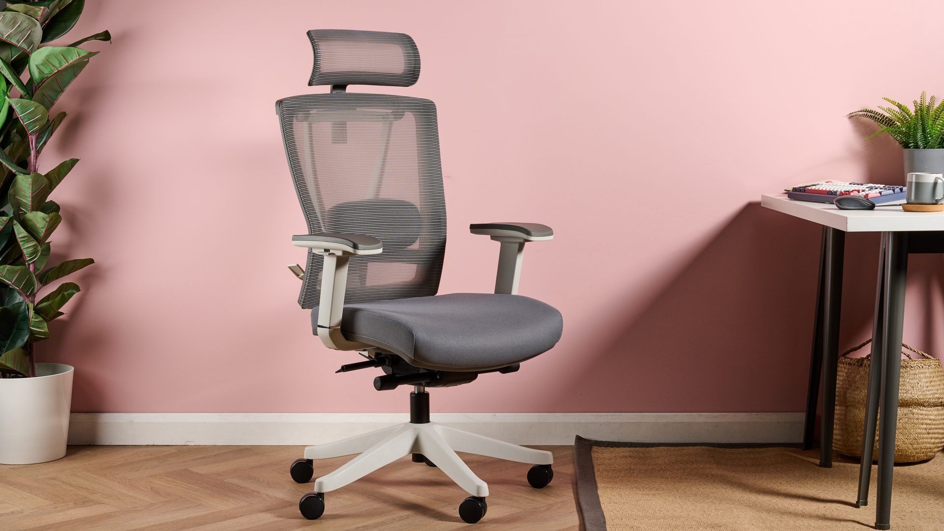 The FlexiSpot Ergonomic Office Chair BS14 is pictured against a pink background.