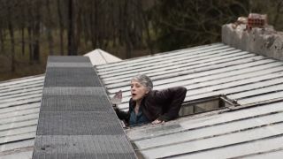 Screenshot of Carol escaping greenhouse through roof in The Walking Dead: Daryl Dixon - The Book of Carol