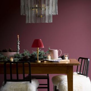 dining room with large glass contemporary chandelier and raspberry walls