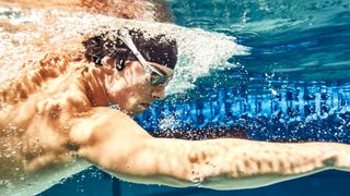 A swimmer wearing bone conduction headphones
