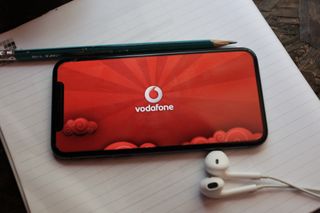 A smartphone on a notepad with Vodafone data