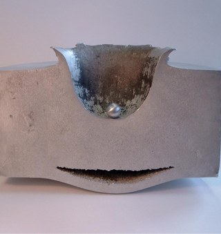 Even tiny pieces of space debris can have catastrophic effects. This image shows the result of a lab-test impact between a block of aluminum and a small aluminum sphere traveling at nearly 7 kilometers per second.
