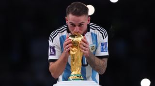 Argentina's Alexis Mac Allister kisses the World Cup trophy after victory over France in Qatar.