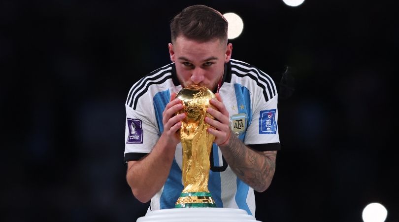 Argentina&#039;s Alexis Mac Allister kisses the World Cup trophy after victory over France in Qatar.