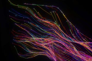 abstract flowing data made out of numbers and glowing turbulent multi coloured splines on black background