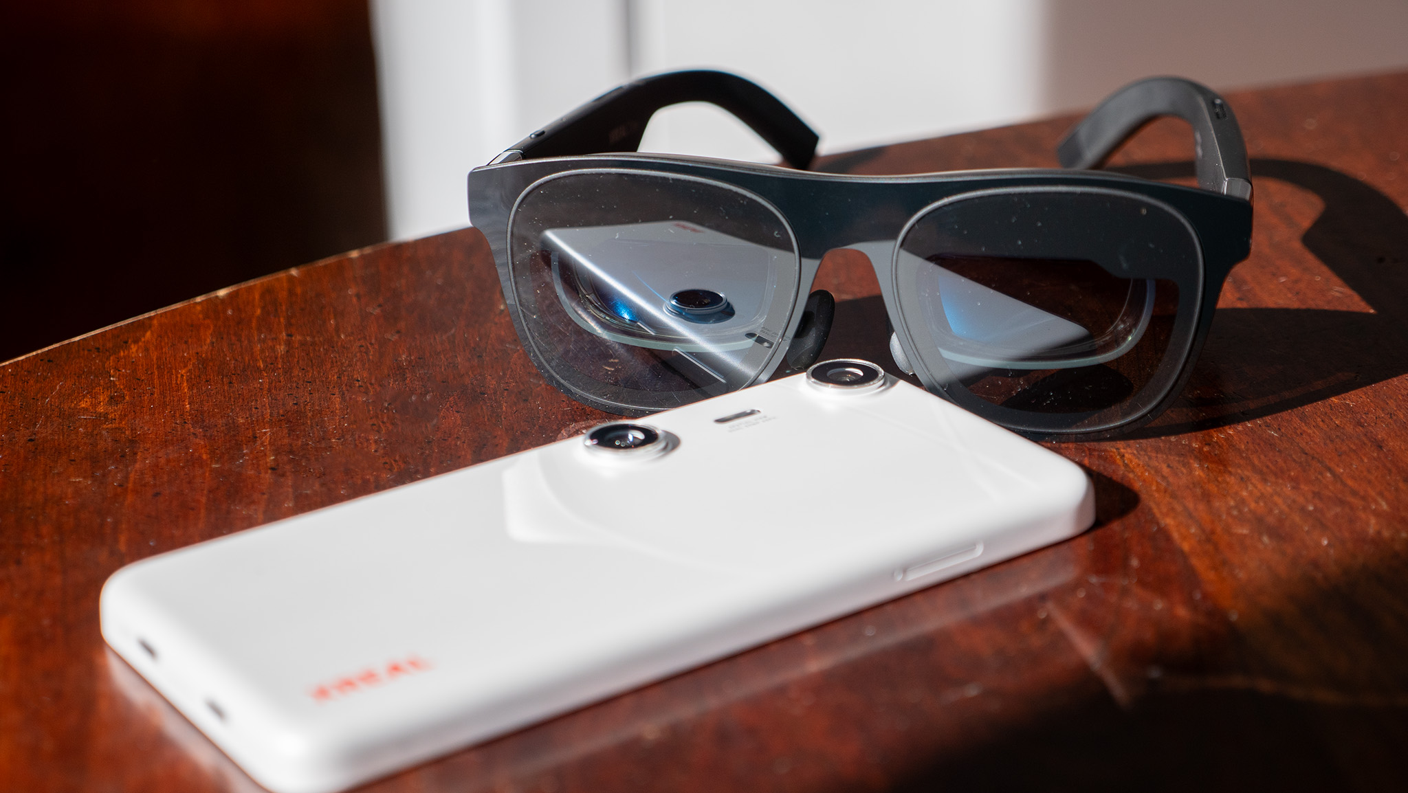 A pair of Xreal One glasses hooked up to an Xreal Beam Pro