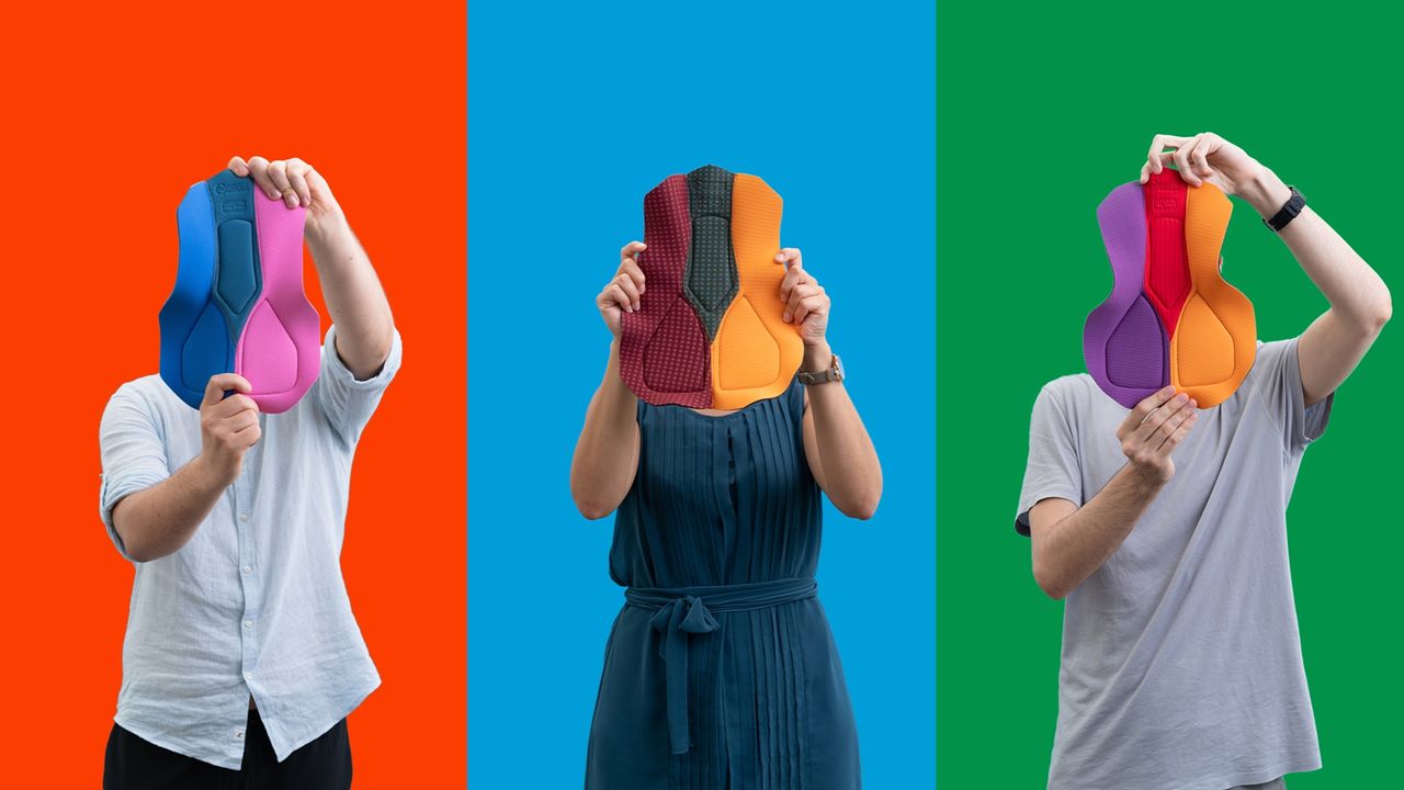 Elastic interface (I&#039;m)Perfect Chamois being held up by three people on colourful backgrounds