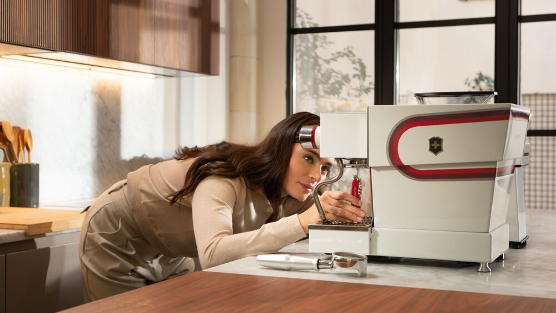 The Victorinox x La Marzocco Barista Tool being used in the kitchen