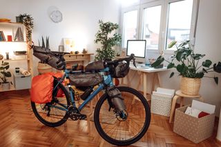 A fully packed and ready to ride bike packing bike in the front room of a home