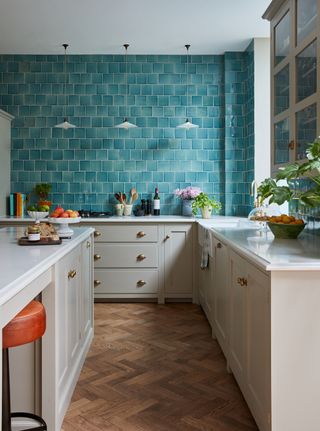 L-shaped kitchen with wall of blue tiles
