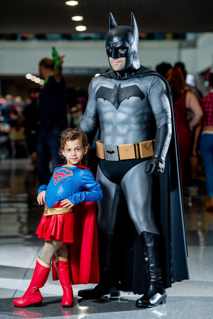 Cosplayers dressed as Superman and Batman pose at New York Comic Con.