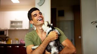 man laughing with dog