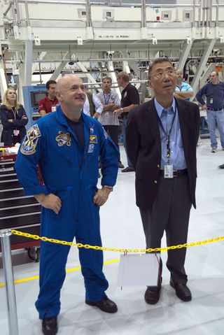 Endeavour shuttle commander Mark Kelly, left, and Nobel laureate Sam Ting (principal investigator for the Alpha Magnetic Spectrometer) look over the instrument as it sits in a work stand at NASA's Kennedy Space Center in Florida. Kelly will command the ST