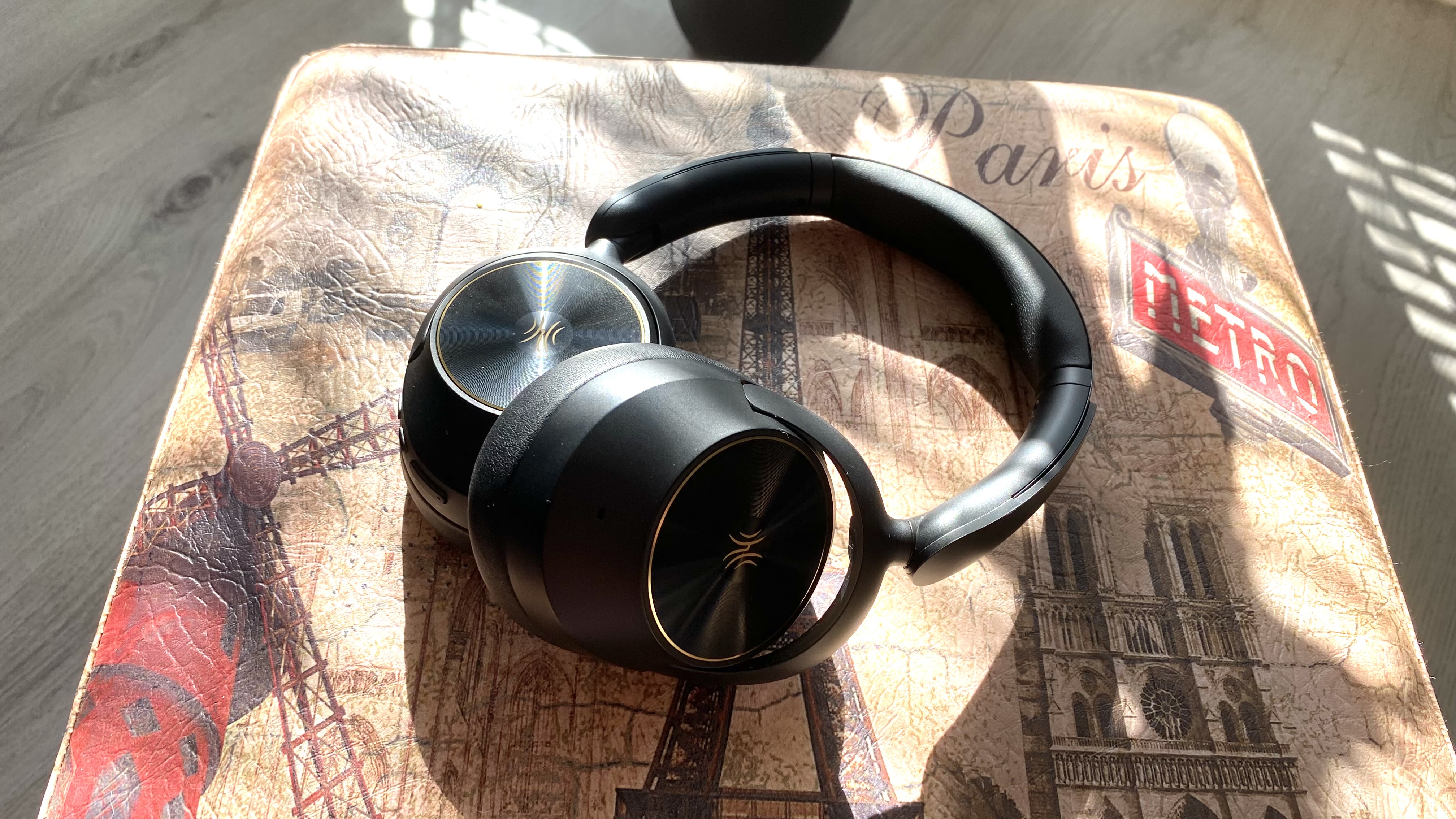 OneOdio Focus A6 over-ear headphones on a Parisian stool
