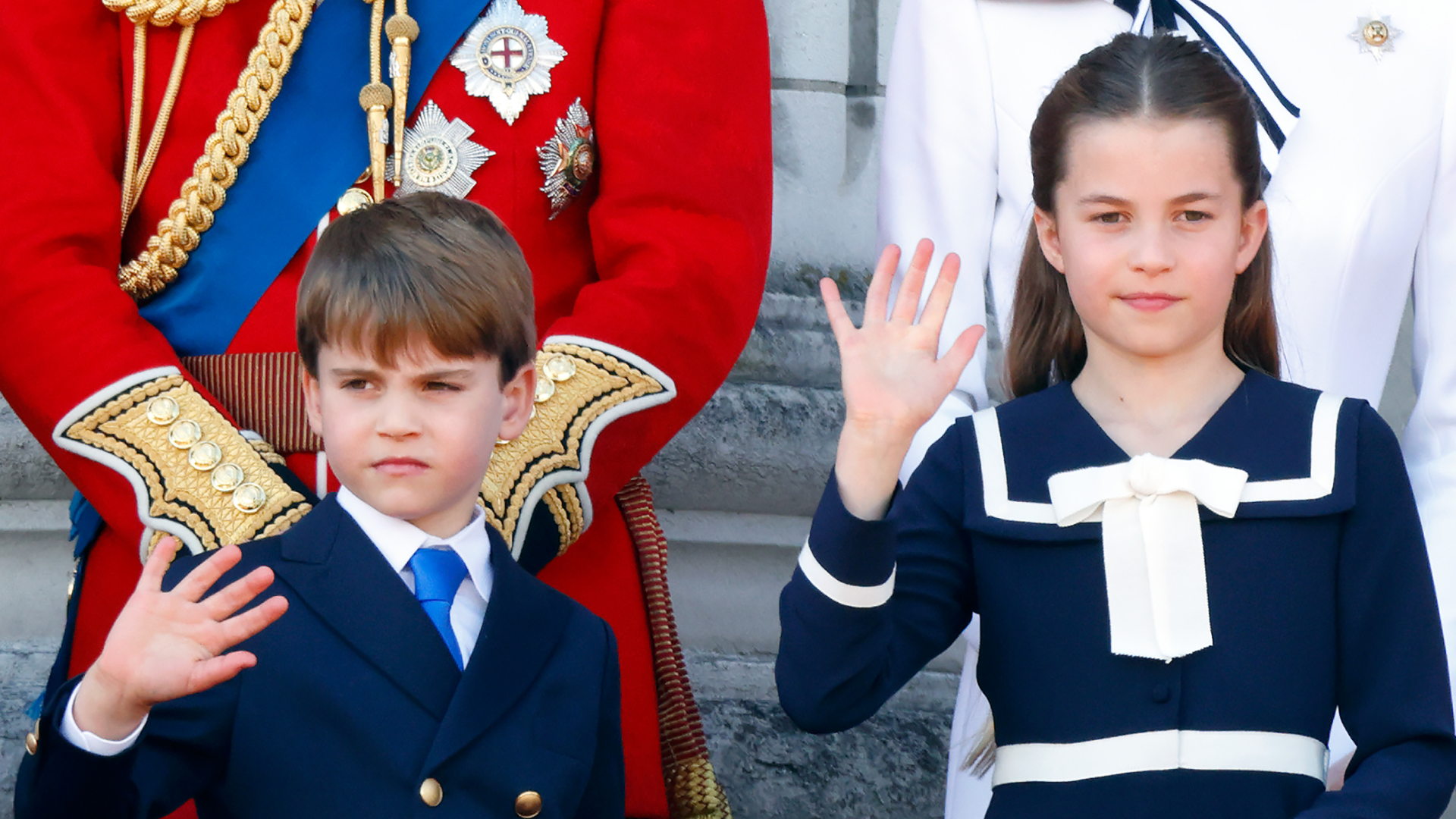 Princess Charlotte and Prince Louis waving on the balcony during Trooping the Colour 2024