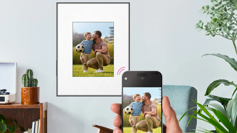 Aluratek ePaper 13.3” WiFi Digital Photo Frame with mobile phone in foreground to show image being transferred