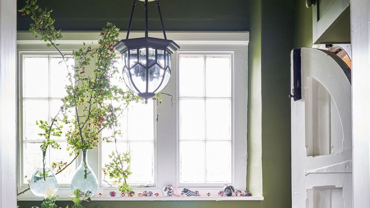 Green hallway with chandelier light