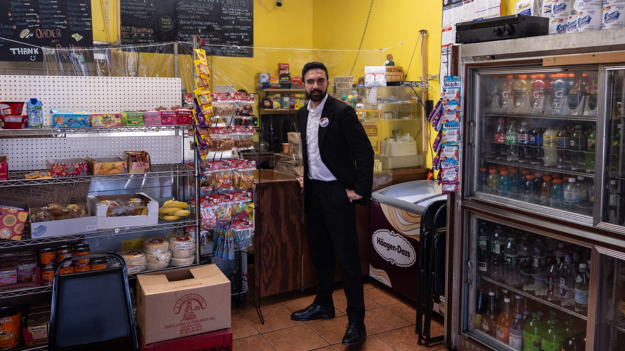 Zohran Mamdani, New York City mayoral candidate, orders an iced coffee from a deli after a campaign event in Queens