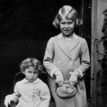 Princess Elizabeth and Princess Margaret posing in dress coats as children