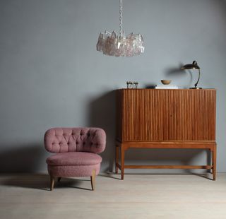 Pink fluffy chair, wooden cabinet