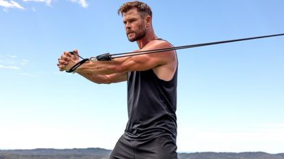 Chris Hemsworth working out with a resistance band
