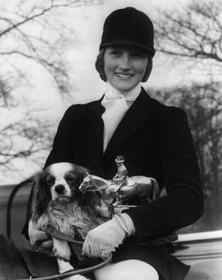 16th April 1973: Lucinda Prior-Palmer, aged 19, the winner of the Badmington Horse Trials, pictured in her riding outfit with the trophy and her pet dog, 'Oliver'.