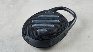 A black JBL Clip 5 portable Bluetooth speaker