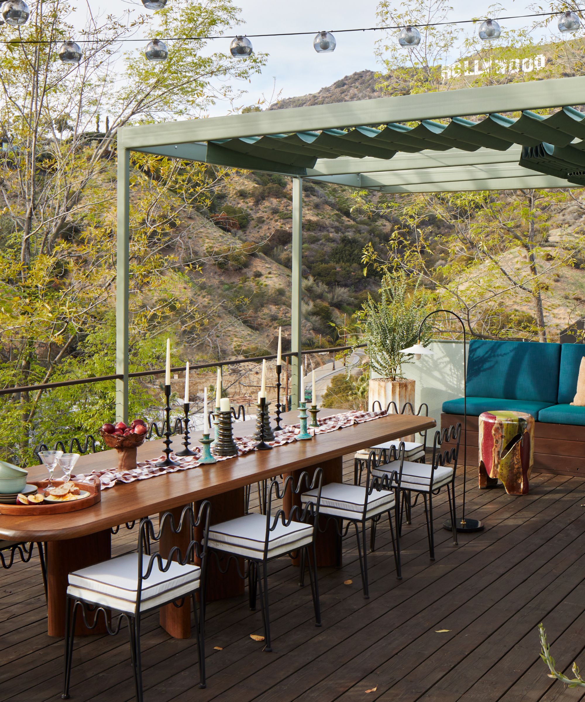 Studio Keeta outdoor dining table styled with a variety of candlesticks