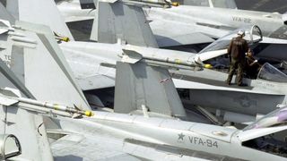 F/A-18 jets from VFA-94 parked on the deck of a carrier
