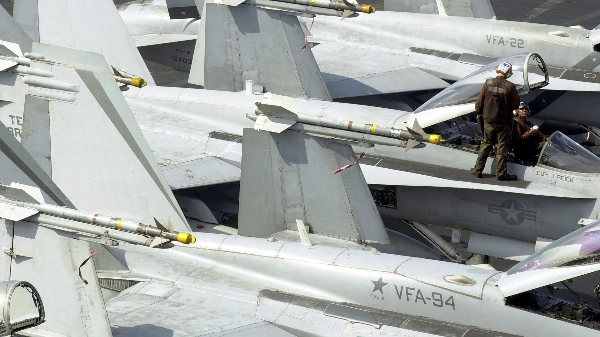 F/A-18 jets from VFA-94 parked on the deck of a carrier
