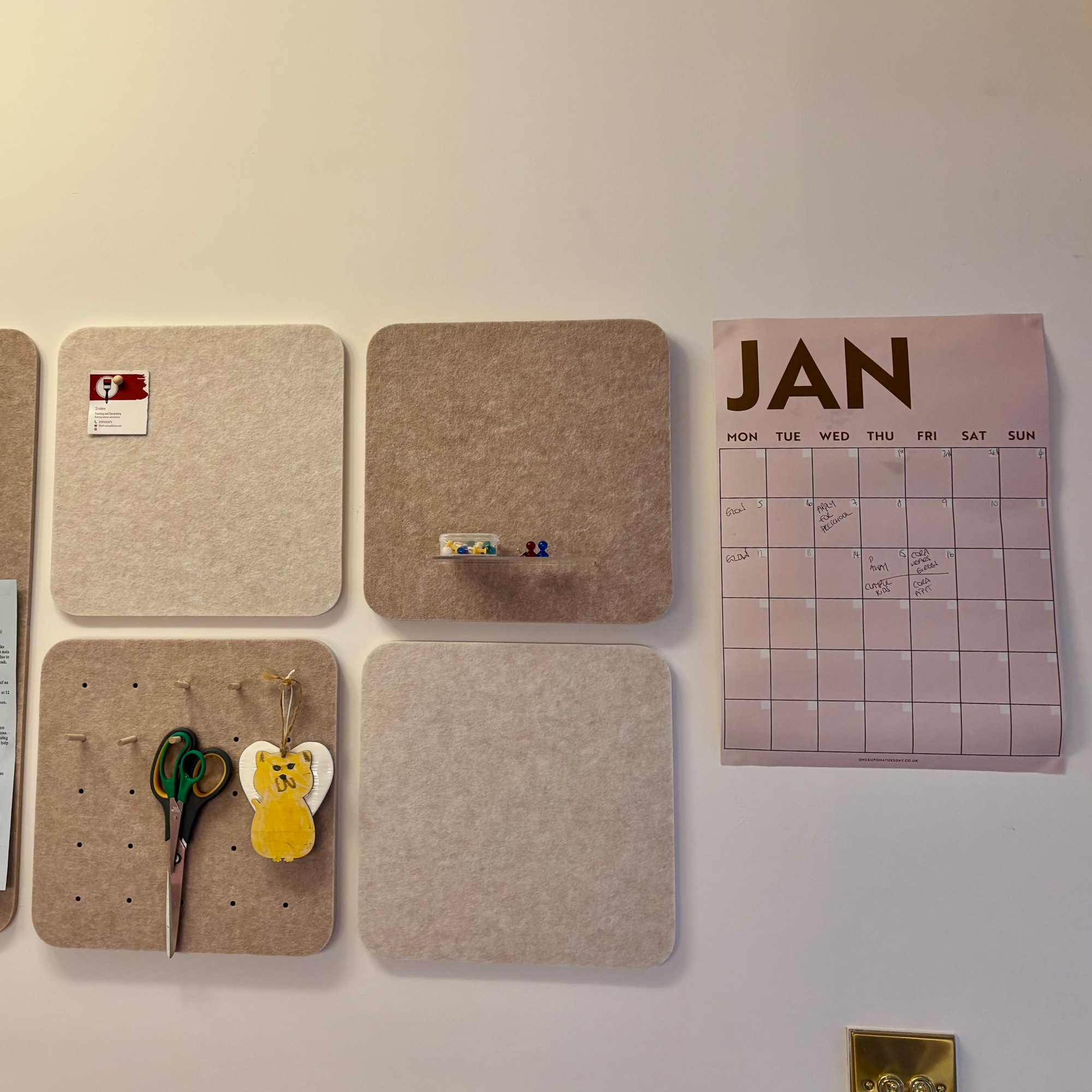 pinboards on a wall with a January wall calendar