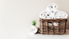 Rolled towels in a brown wicker basket