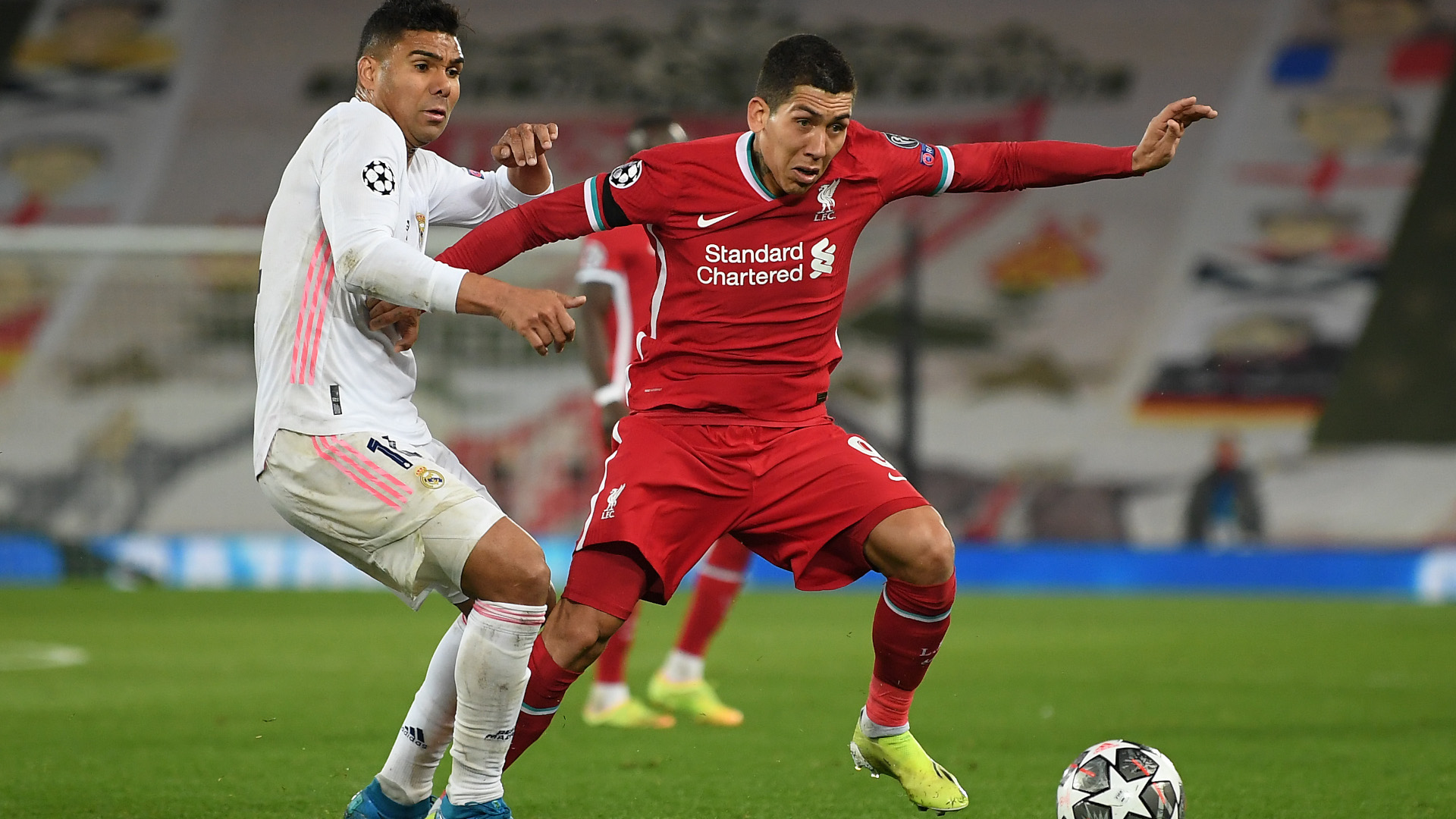 Firmino and Casemiro fight for the ball