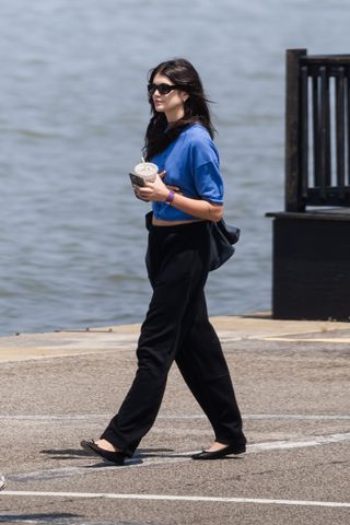 kaia gerber walking in New York City wearing her Repetto ballet flats with sweatpants and a blue t-shirt