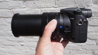 Sony RX10 IV bridge camera being held in a reviewer's hand