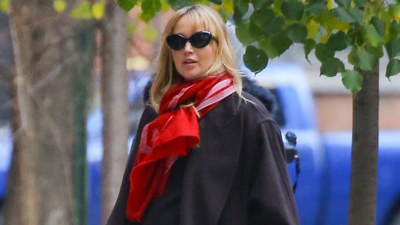 jennifer lawrence wearing a black coat and a red scarf