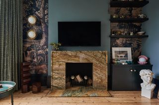 Statement marbled fireplace in a darkly painted room