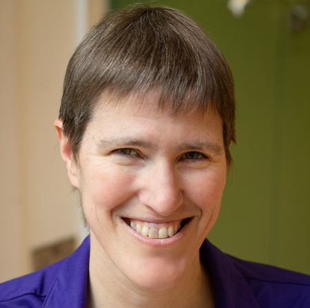 White woman with short hair smiling
