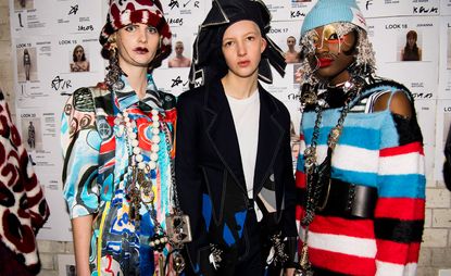 Three male models wearing colourful clothing by Charles Jeffrey.
