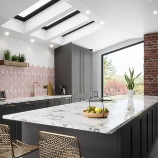 kitchen with marble countertop and pink tiles