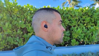 Our reviewer demonstrating comfort on the Jabra Elite 4 Active