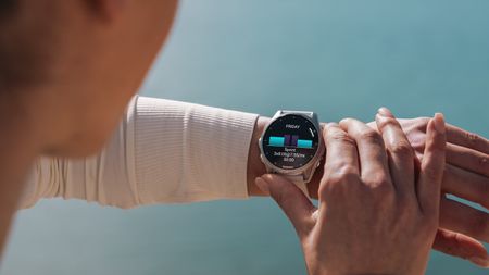 Photo of the Garmin Fenix 8 on an athlete's wrist, showing a daily suggested workout.