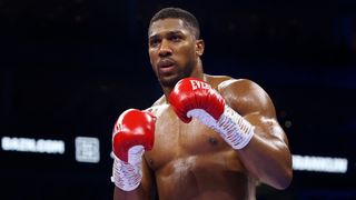 Anthony Joshua wearing red and white boxing gloves, in the ring, ahead of the Anthony Joshua vs Otto Wallin fight in Riyadh, Saudi Arabia.