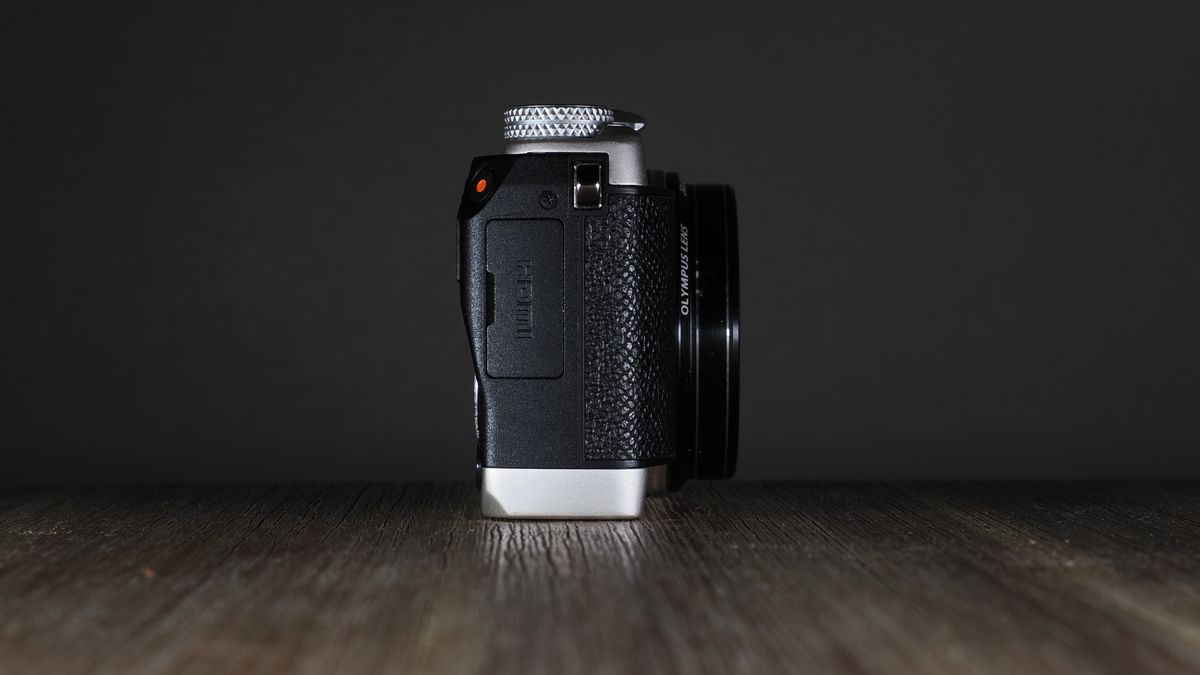 Olympus Stylus SH-3 on a wooden surface