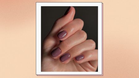 close up of woman's hand wit mauve nails