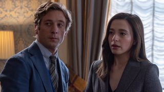 Jeremy Allen White in a blue suit and striped tie, standing next to Mikey Madison in a dark jacket in a room at the Capitol in The Social Reckoning. 
