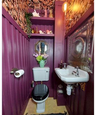 Purple cloakroom with floral wallpaper by Claire Ballantyne