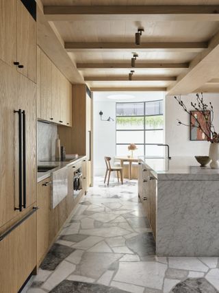 A kitchen with cabinets that go all the way to the ceiling