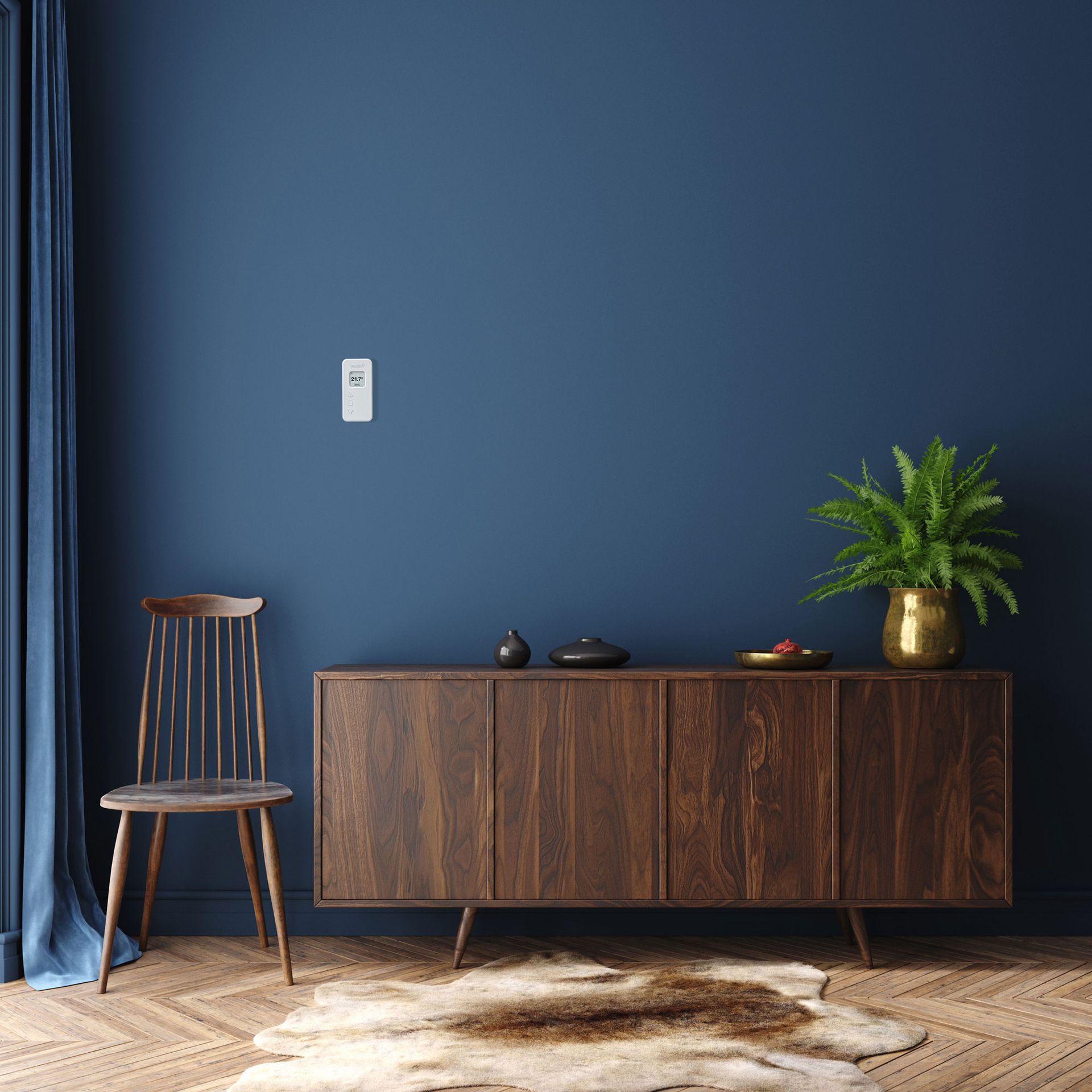 dark blue living room with walnut sideboard and herringbone wooden flooring with smart thermostat on wall