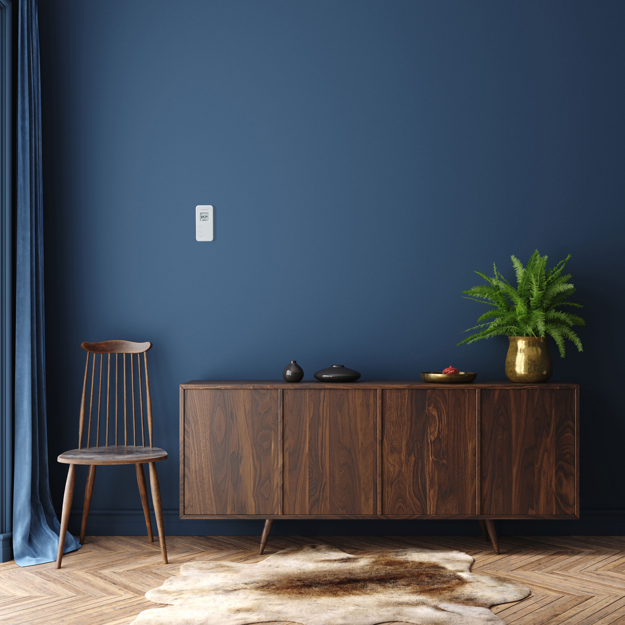 dark blue living room with walnut sideboard and herringbone wooden flooring with smart thermostat on wall